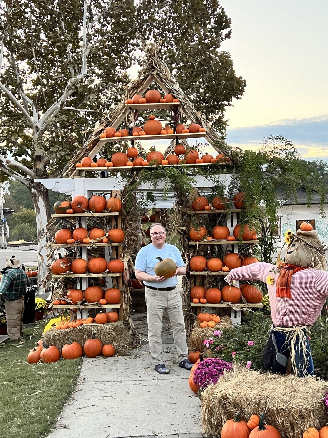 Chris VanCleave holding a pumpkin at a fall pumpkin patch